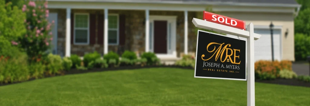 Sold real estate sign in front of a home